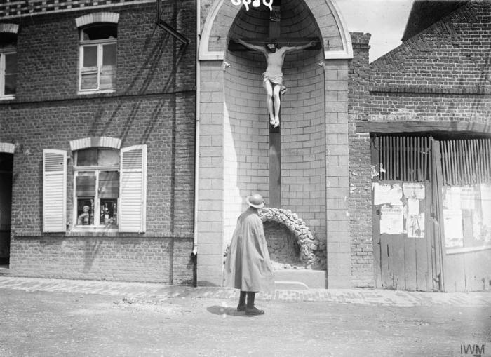 British soldier looking at a crucifix in Fleurbaix, June 1916. (IWM Q690)